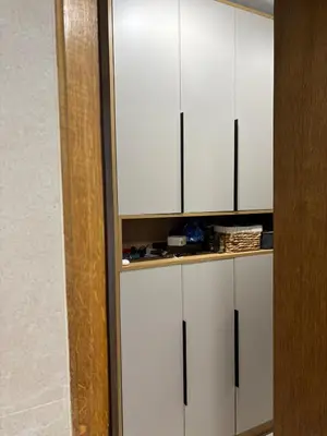a white cabinet with black handles in a room at LuxeStay Ksenija apartment in Podgorica