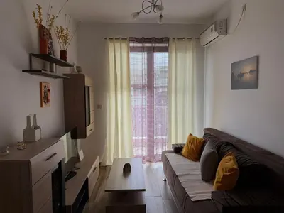 a living room with a couch and a large window at Modern Apartment Przno in Pržno