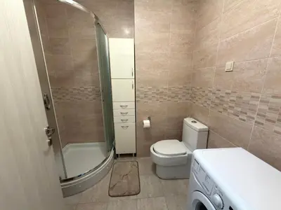 a small bathroom with a toilet and a shower at Modern Apartment Przno in Pržno