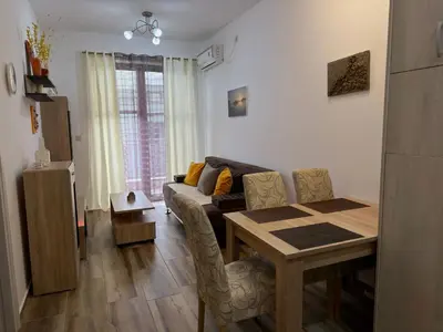 a living room with a table and a couch at Modern Apartment Przno in Pržno