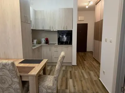 a kitchen with a table and chairs in a room at Modern Apartment Przno in Pržno