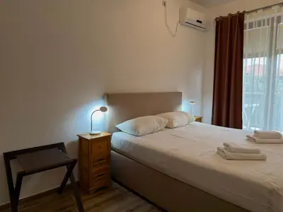 a bedroom with a bed and a chair and a window at Modern Apartment Przno in Pržno