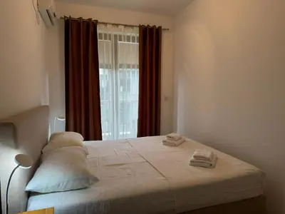 a bedroom with a bed with two towels on it at Modern Apartment Przno in Pržno