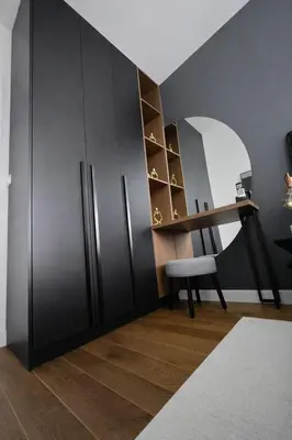 a room with a black refrigerator and a chair at Urban Forest Apartment - with free Garage in Podgorica