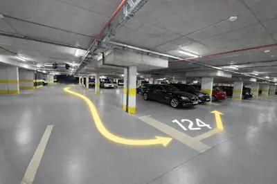 a parking lot with cars parked in a parking garage at Urban Forest Apartment - with free Garage in Podgorica