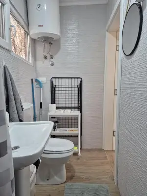 a bathroom with a white toilet and a sink at Amore Studio Apartment in Bar, Susanj