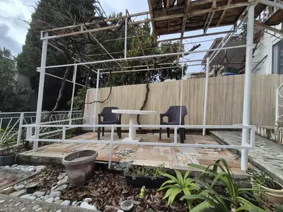 a table and two chairs on a wooden deck at Amore Studio Apartment in Bar, Susanj