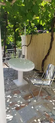 a white table and two chairs on a patio at Amore Studio Apartment in Bar, Susanj