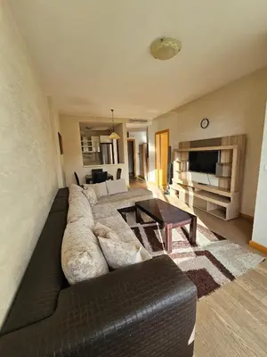 a living room with a couch and a table at Kadmo Sea View Apartment in Budva