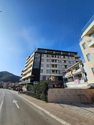 a tall building on the side of a street at Kadmo Sea View Apartment in Budva