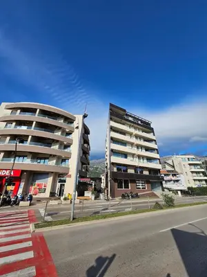 two tall buildings on a street in a city at Kadmo Sea View Apartment in Budva