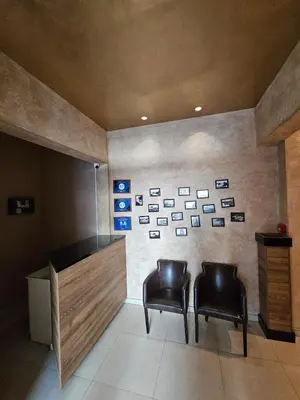 two chairs in a room with pictures on the wall at Kadmo Sea View Apartment in Budva