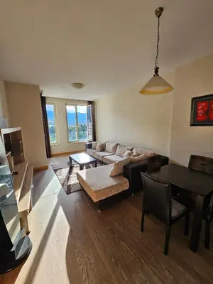 a living room with a couch and a table at Kadmo Sea View Apartment in Budva