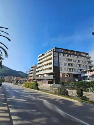 an empty street in front of a large building at Kadmo Sea View Apartment in Budva