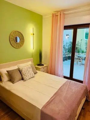 a bedroom with a large bed with a large window at Blue Sea apartment Petrovac in Petrovac na Moru