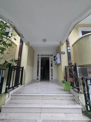 an empty hallway leading to a building with stairs at Blue Sea apartment Petrovac in Petrovac na Moru