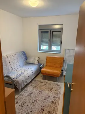 a living room with a couch and a chair at Njaro del Mar Petrovac Bay in Petrovac na Moru
