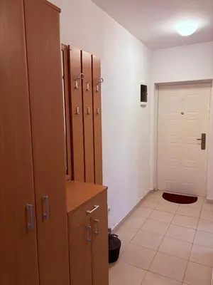 a locker room with wooden cabinets and a door at Njaro del Mar Petrovac Bay in Petrovac na Moru