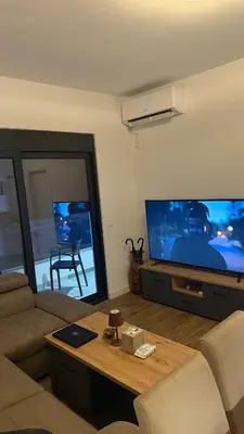 a living room with a couch and a flat screen tv at Morea Apartments in Ulcinj