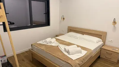a bedroom with a bed with towels on it at Morea Apartments in Ulcinj