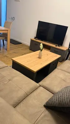 a living room with a couch and a table with a tv at Morea Apartments in Ulcinj