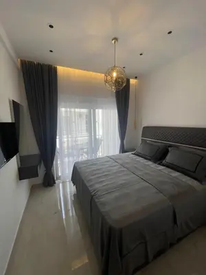 a bedroom with a large bed and a large window at Apartments Amira in Ulcinj