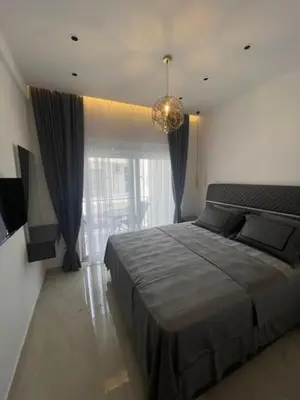 a bedroom with a large bed and a large window at Apartments Amira in Ulcinj