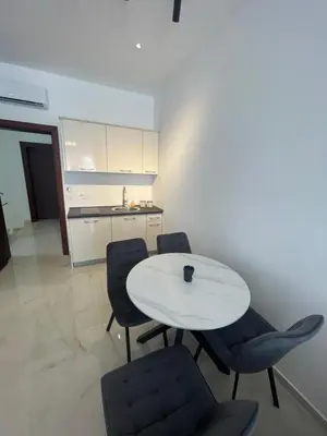 a white table and chairs in a kitchen at Apartments Amira in Ulcinj