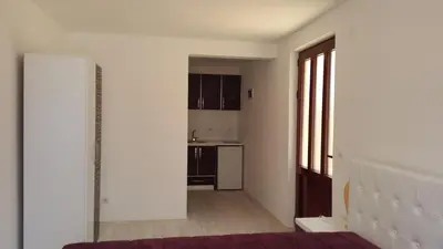 an empty room with a kitchen and a hallway at Apartments Villa Royale in Dobra Voda