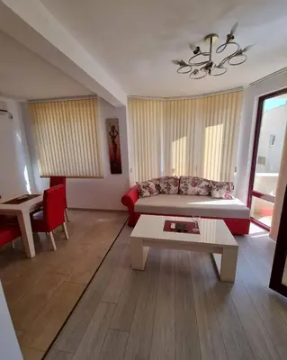 a living room with a couch and a table at Apartments Villa Royale in Dobra Voda