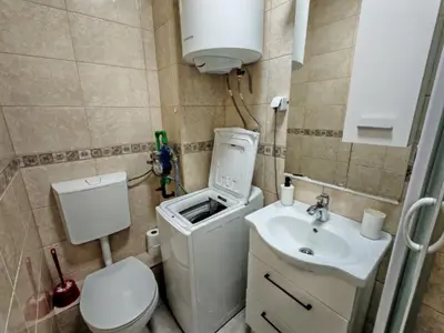 a small bathroom with a toilet and a sink at Veli Vinogradi in Budva
