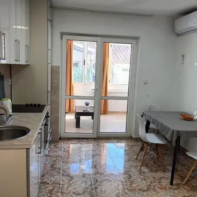a kitchen with a door leading to a patio at Veli Vinogradi in Budva