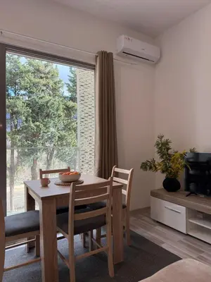 a dining room with a table and a large window at Golden LUX in Bar