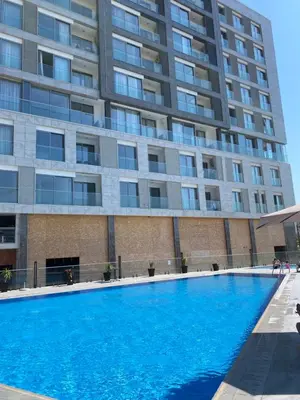a swimming pool in front of a building at Golden LUX in Bar