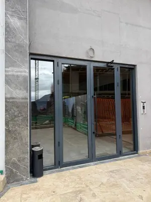 an open glass door of a building with a trash can at Golden LUX in Bar