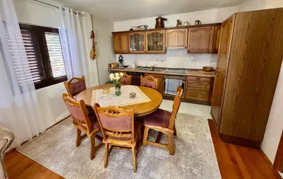 a kitchen with a wooden table and chairs at Cindarella Apartment in Kotor