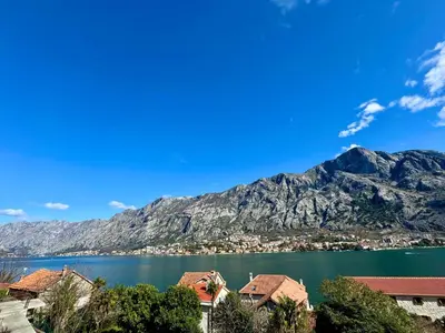 a view of a lake with a mountain in the background at Cindarella Apartment in Kotor