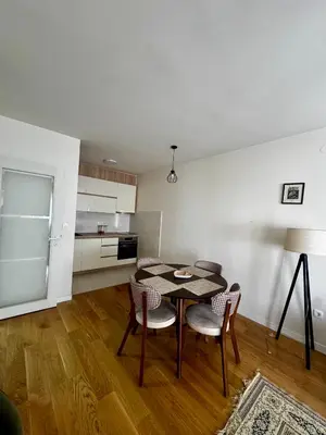 a kitchen and dining room with a table and chairs at Urban Stay in Podgorica