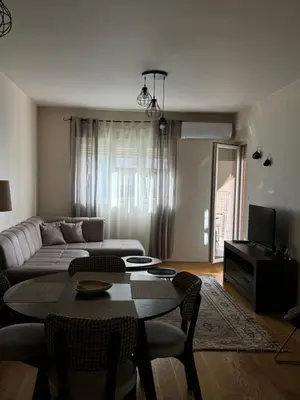 a living room with a couch and a table at Urban Stay in Podgorica