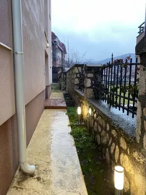 a street with candles on the side of a building at Jednosoban namješten stan - Cetinje in Cetinje