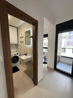 a bathroom with a sink and a mirror at Mayne Apartmant in Budva