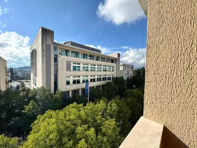 a large office building with trees in front of it at The Government District Suite in Podgorica