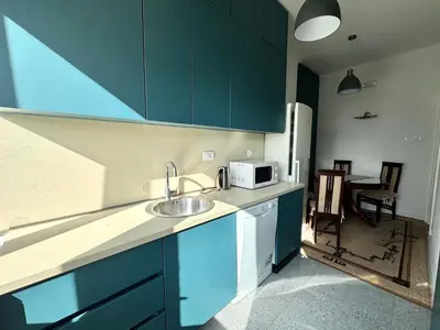 a kitchen with a sink and a microwave at The Government District Suite in Podgorica