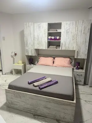 a bedroom with a large bed with two towels on it at ALEKS apartman in Rafailovici