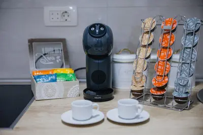 a kitchen counter with cups and a hair drier at The Point - Modern City Apartment in Kruševac