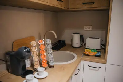a kitchen counter with a sink and appliances on it at Urban Stay - Central Point Apartment in Kruševac