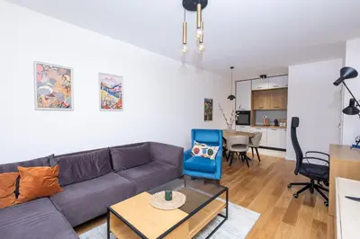 a living room with a couch and a table at Urban Stay - Central Point Apartment in Kruševac