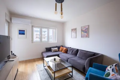 a living room with a couch and a table at Urban Stay - Central Point Apartment in Kruševac