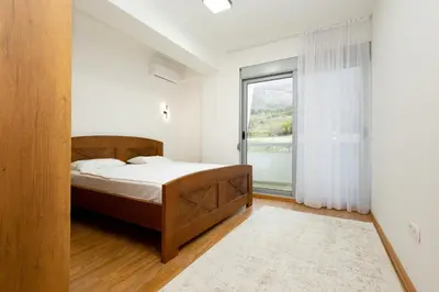 a bedroom with a bed and a large window at Apartment sea view Asija in Bar