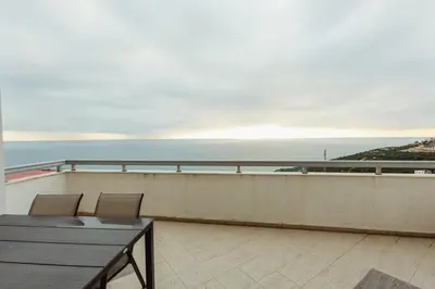 a balcony with a table and chairs and the ocean at Apartment sea view Asija in Bar